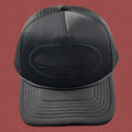 Cortiez All-Black Monochromatic Oval Ship Logo Trucker Hat